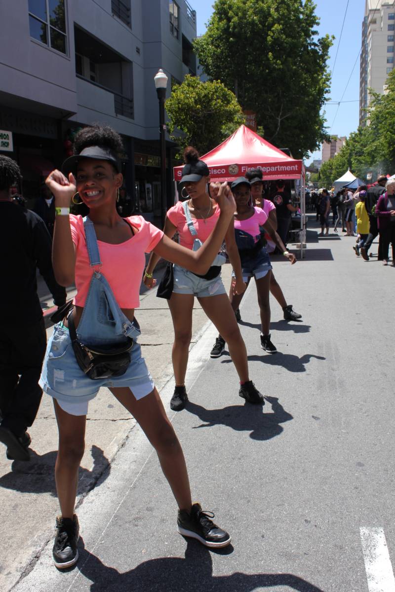 Members of the Lyric Performing Arts Academy dance down Fillmore Street as part of San Francisco's Juneteenth celebration.