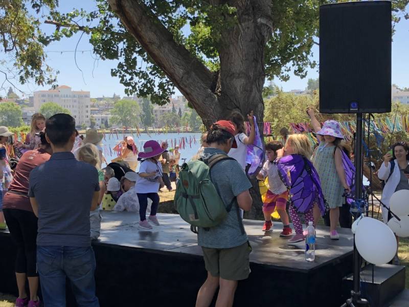 Kids have a dance party at the 'Families Belong Together' rally in Oakland near Lake Merritt.