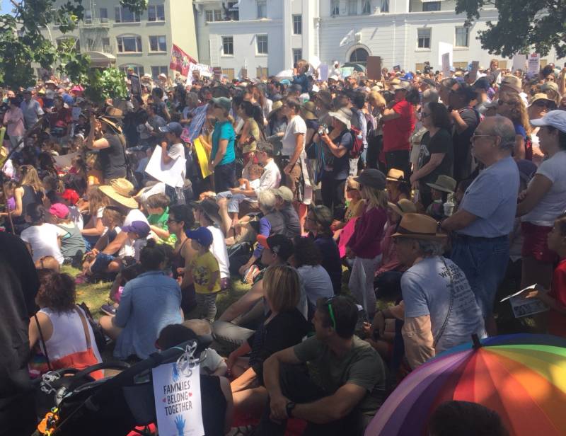 A large crowd fills Lakeside Park in Oakland for a 'Families Belong Together' rally.