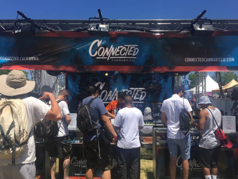 Customers line up for some "#designerweed" from Connected Cannabis, one of the many corporate cannabis companies at the Cannabis Cup. Their booth had a DJ and a smoking lounge.
