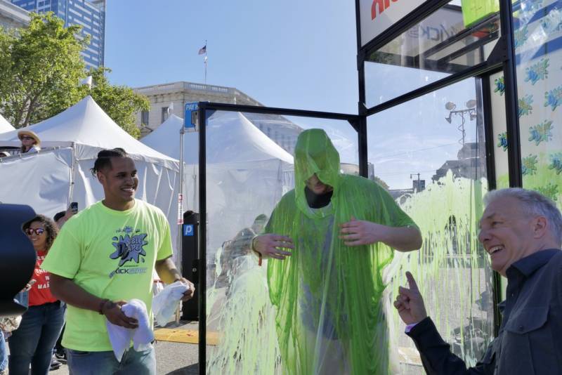 Brad Koelling from Dublin, California, emerges from a tank after being slimed, his prize for beating out a dozen contestants on an obstacle course from 'Double Dare,' the classic '80s and '90s television show on Nickelodeon at Clusterfest.