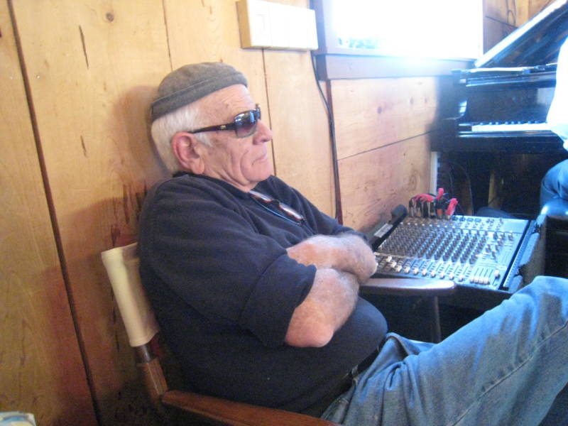 Pete Douglas running the sound system just off of stage right in the performance room at the Bach Dancing and Dynamite Society. Douglas died in 2014.