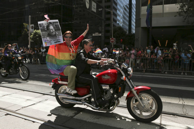 Dykes on Bikes members open up the 2018 San Francisco Pride Parade while carrying a sign commemorating Soni Wolf. Wolf, a co-founder for the group, was selected to be a community grand marshal but passed away two months before the event.