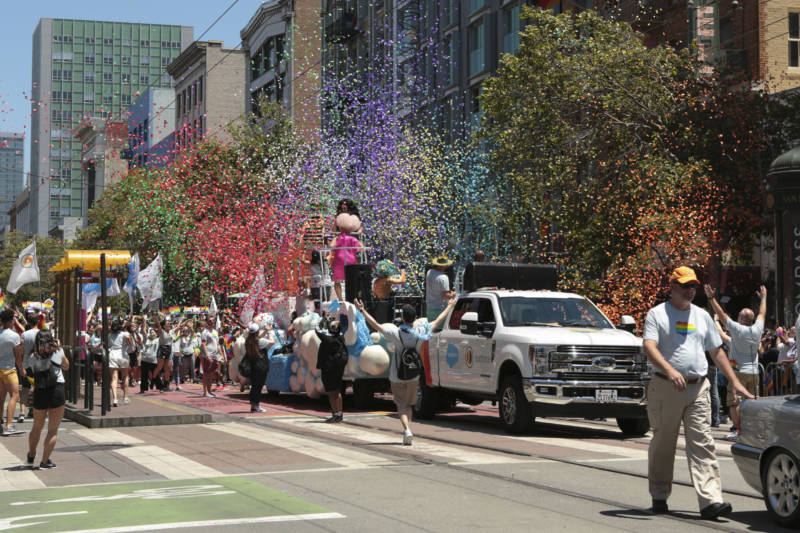 Bits of rainbow-colored paper spray into the air as the Salesforce float passes along Market Street. There were more than 280 contingents in the parade, according to organizers.