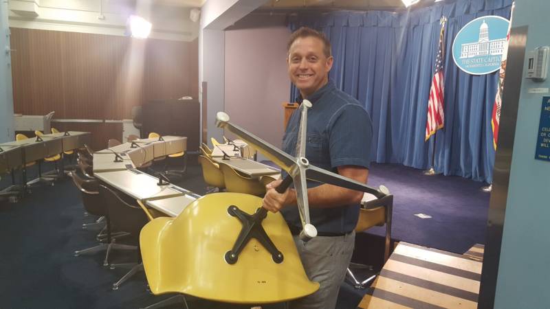  Sacramento appraiser Brian Witherell holds up a chair in the Capitol press room.