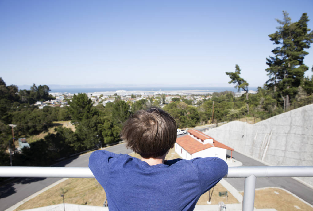 Alex Kornblum looks out over the San Francisco Bay from the top of a water storage tank at the Harry Tracy Water Treatment Plant in San Bruno, Calif. 