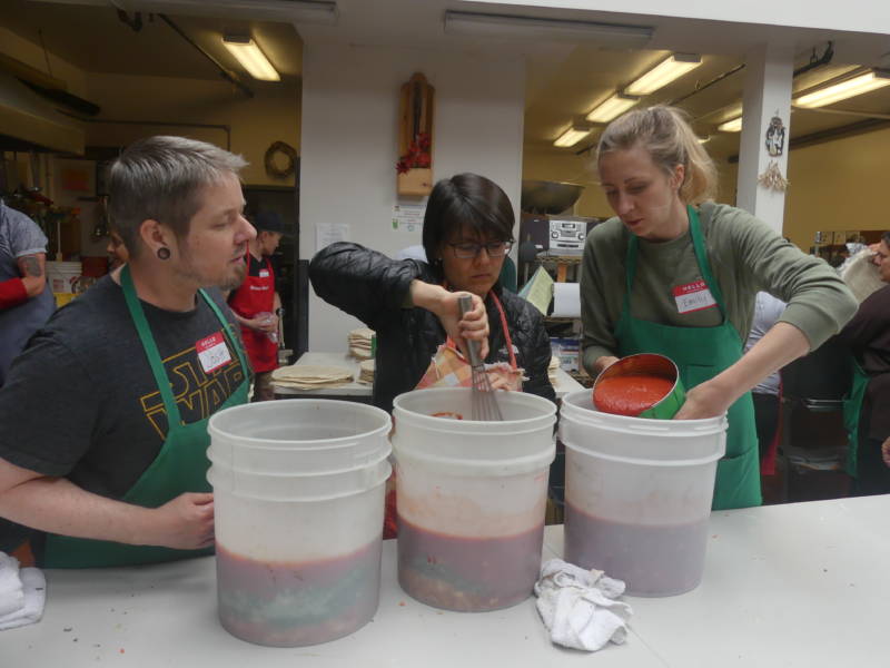 You can't judge how hungry people living on the streets might be, says Emily Durenberger, pouring sauce when she's not busy orienting new volunteers. It's important not just to feed but interact with people who are too often ignored, she says.