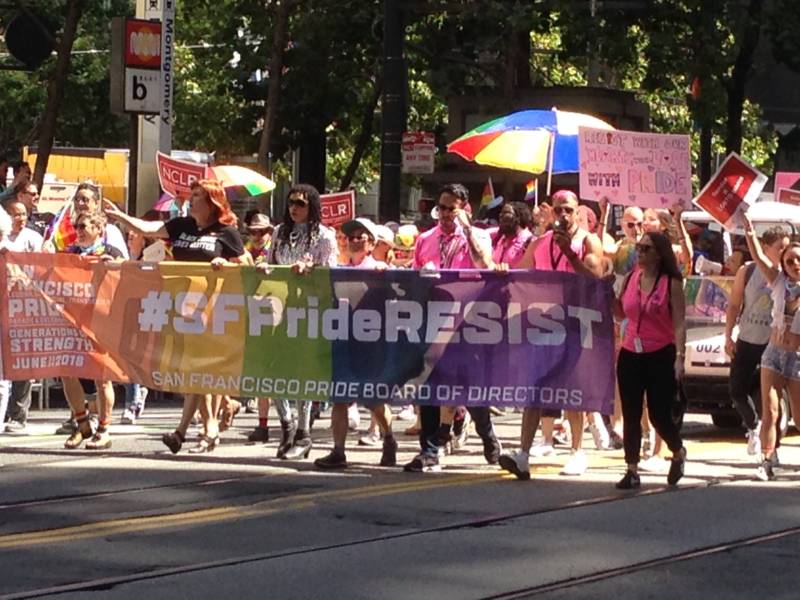 The San Francisco Pride Board of Directors contingent carrying an #SFPrideRESIST banner. Other marchers held signs Some marchers held signs for issues including family separation, the border wall, gun reform and more.