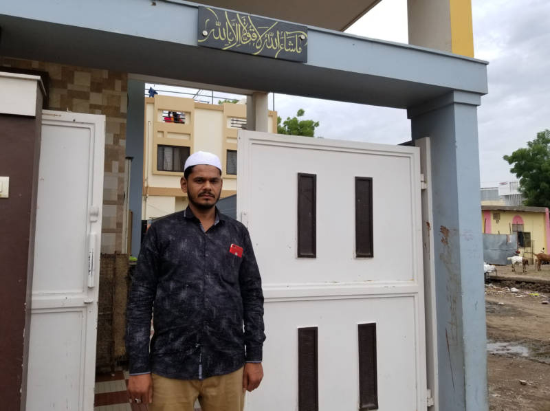 Shaikh Wasim Shaikh Karim, 32, rescued five people from an angry mob in front of his home earlier this month. He pulled the victims — a couple, their toddler and two relatives — to safety behind this gate, as the mob shattered his windows with stones.