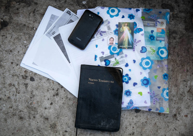 Birth certificates, IDs, prayer cards and a bible are among the items carried by those waiting to apply for asylum.