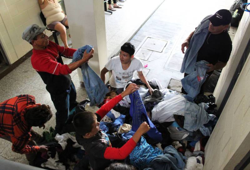 Refugees and immigrants look through a pile of clothes in Zona 1, Guatemala City.