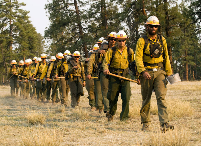 Wildland firefighters, like this crew heading into New Mexico’s Gila National Forest, in 2012, are equipped and operate differently from urban firefighters.