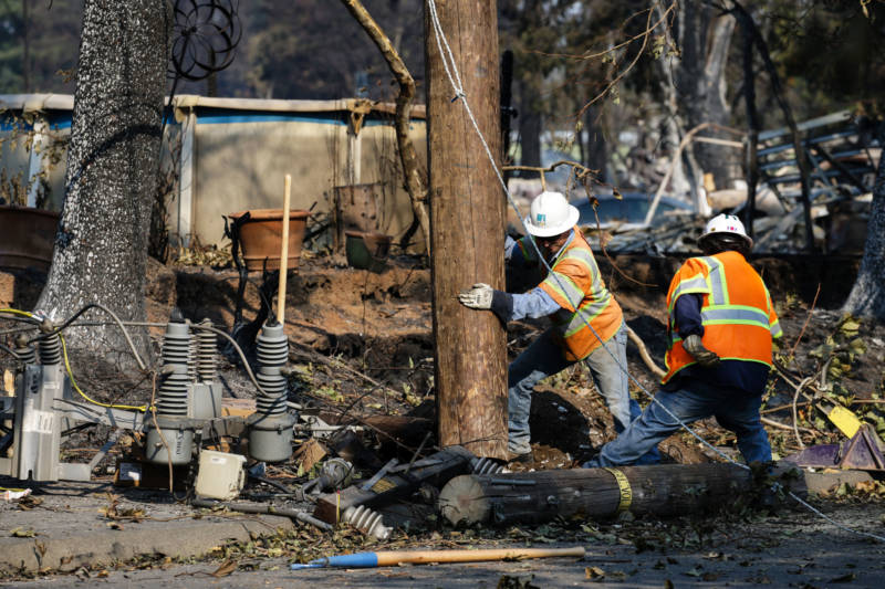 PG&E workers work to repair power lines in the Coffey Park neighborhood following the devastation caused by the Tubbs Fire on October 13, 2017 in Santa Rosa.