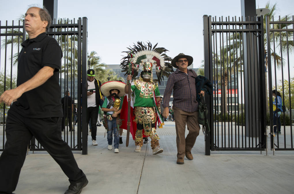 Alfredo Gonzalez and his son Angel, age 8, walk past the stadium gates wearing Aztec and Pancho Villa costumes. "We want to make sure we represent our team and show support, and this is a nice way to do it," he said. "It's not going to be easy, but other teams have done it and we're going to do it, too."