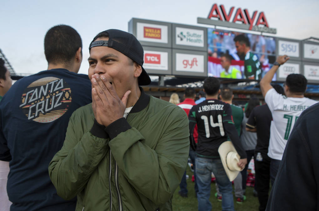 Kevin Aquino, who traveled from Fremont to watch "Mexico win" with his friends, reacts to a the first blocked goal attempt.