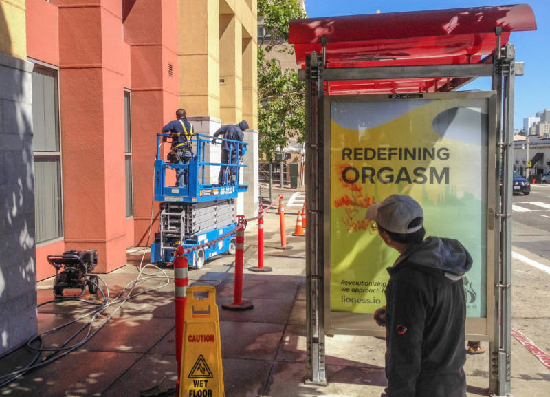 An ad for a "smart" vibrator could not compete for attention with workers washing a building at Van Ness Avenue and Jackson Street in San Francisco.