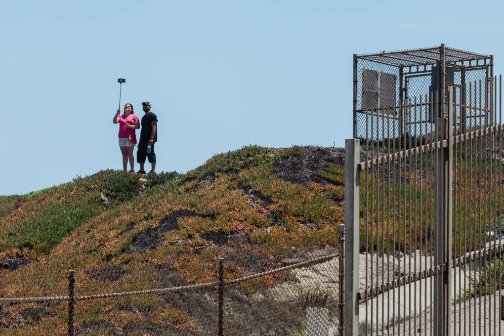 People take a selfie outside of Friendship Park in San Ysidro, Calif. Friendship Park is open on Saturdays and Sundays for four hours. Friends and family members are able to visit one another and speak through a metal fence.