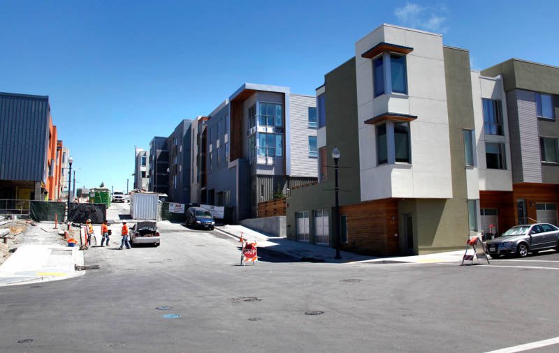 Construction workers outside new apartment buildings in the San Francisco Shipyard development at Hunters Point, in July, 2016.