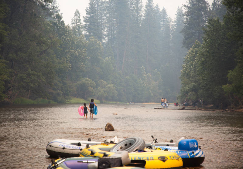 Park-goers raft in the Merced River in Yosemite National Park over the weekend. Decreased air quality due to smoke from the Ferguson Fire and a Highway 140 shutdown from El Portal to the park's West Gate led to much smaller crowd sizes.