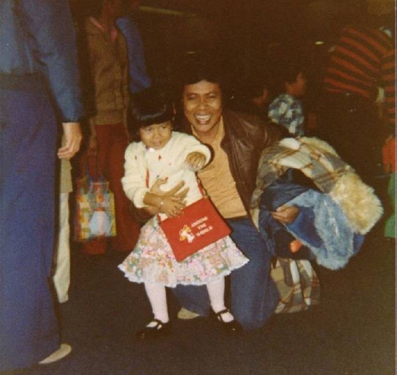Young Glady reunites with her father at San Francisco International Airport.
