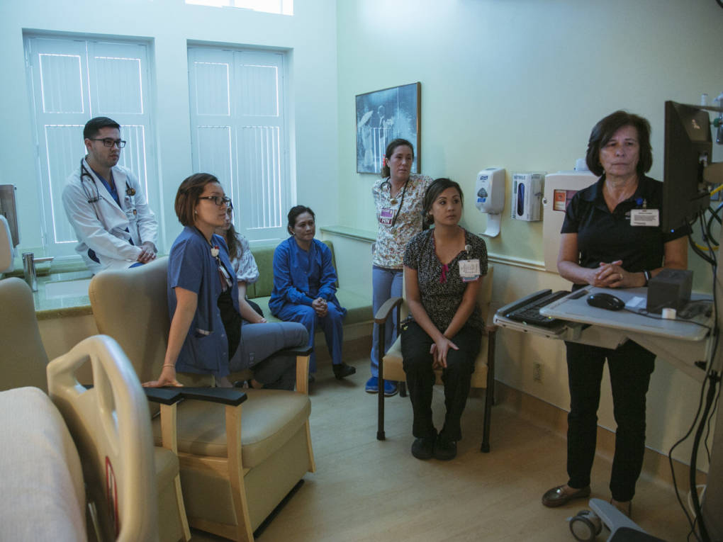 Hospital staff at Pomona Valley Hospital Medical Center review video footage of an emergency drill performed on a medical mannequin.