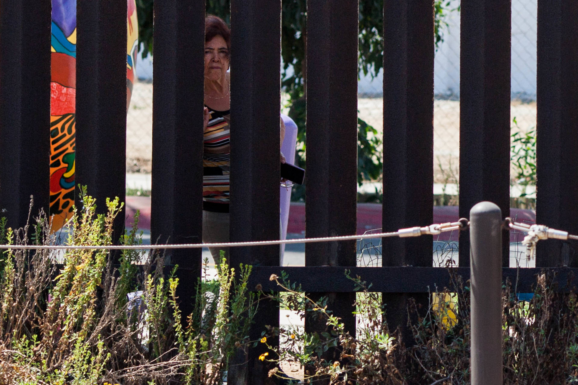 A woman looks through the border fence from Friendship Park in Tijuana.