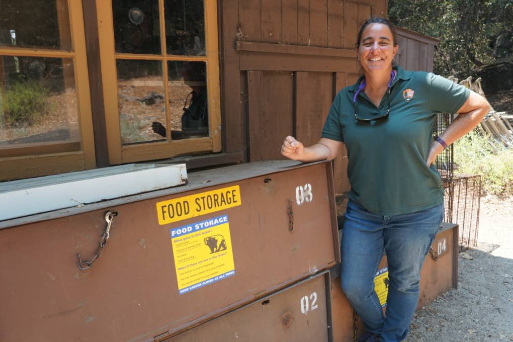 Rachel Mazur, Chief of Wildlife for Yosemite National Park, by a "graveyard" of old bear lockers. She says when bear management is under control, her team can focus on other wildlife efforts, like conservation and restoring endangered species.