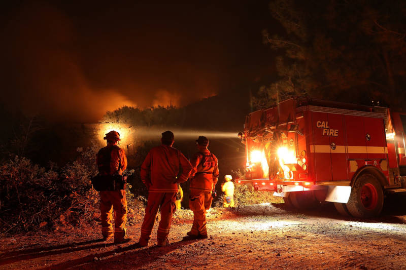 Cal Fire firefighters monitor a back fire while battling the Medocino Complex fire on August 7, 2018 near Lodoga, California.
