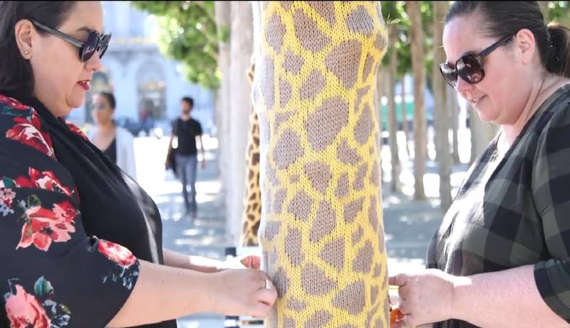 Lorna and Jill Watt (aka Knits for Life) make repairs to a giraffe.