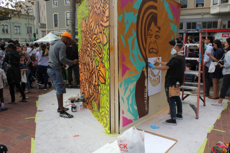 Artists work on their installations at the Oakland Block Party featuring Yo-Yo Ma.