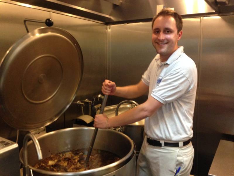 Andrew Binder, fourth generation managing partner of Philippe's restaurant in Los Angeles, stirs 50 gallons of simmering meat that will soon become French dip sandwiches.