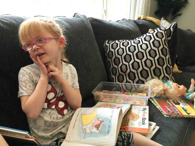 Brooke Adams, 5, who has an intractable form of childhood epilepsy called Dravet Syndrome, reads in her Santa Rosa living room in August 2018.