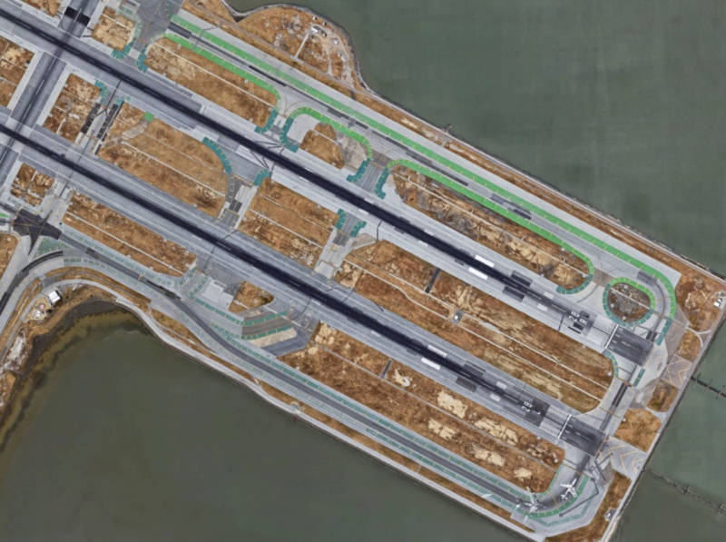 A Google Earth view of Runways 28L and 28R at San Francisco International Airport. During a nighttime landing in July, 2017, an Air Canada flight crew confused a crowded taxiway at the top of this image (outlined in green) with their assigned runway, 28R. The crew's confusion partially stemmed from runway 28L being closed and dark at the time.