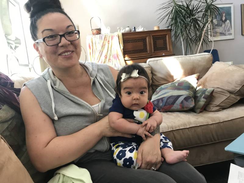 Amika Mota with her 3-month-old daughter in Oakland. Mota was a firefighter in prison but can’t get a similar job on the outside because she’s one of 8 million Californians with a criminal conviction on their record.