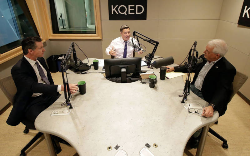 Gavin Newsom (L) and John Cox (R) join KQED's Scott Shafer for their only scheduled gubernatorial debate in KQED's San Francisco studios on Oct. 8, 2018.