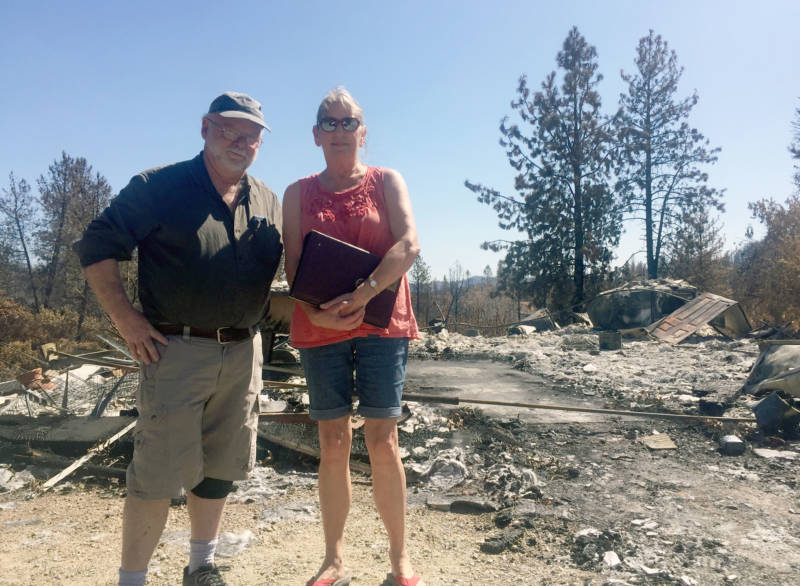 Jim and Donna Dowling stand in front of the rubble that used to be the home they built from scratch 25 years ago outside Redding. It burned down in the Carr Fire in late July.