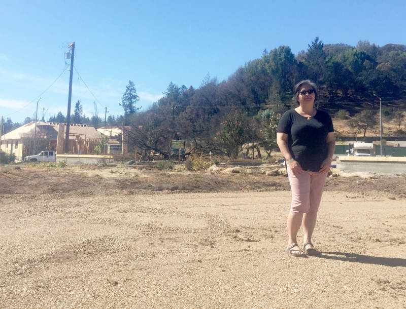 Vita Iskandar stands where her home used to be before it was destroyed by the Tubbs Fire in October 2017. She doesn't know if she'll rebuild.