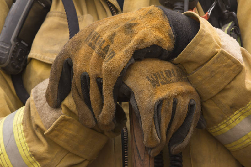 A firefighter holds a hand tool ready to build containment around the Ranch Fire. 
