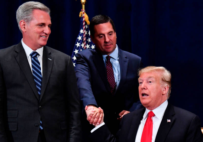 President Trump shakes hands with Rep. Devin Nunes as House Majority Leader Kevin McCarthy looks on, after signing a presidential memorandum focused on sending more water to farmers in the Central Valley.