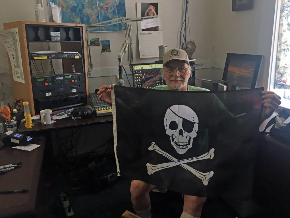 KPFZ station manager Andy Weiss holds up a pirate flag.