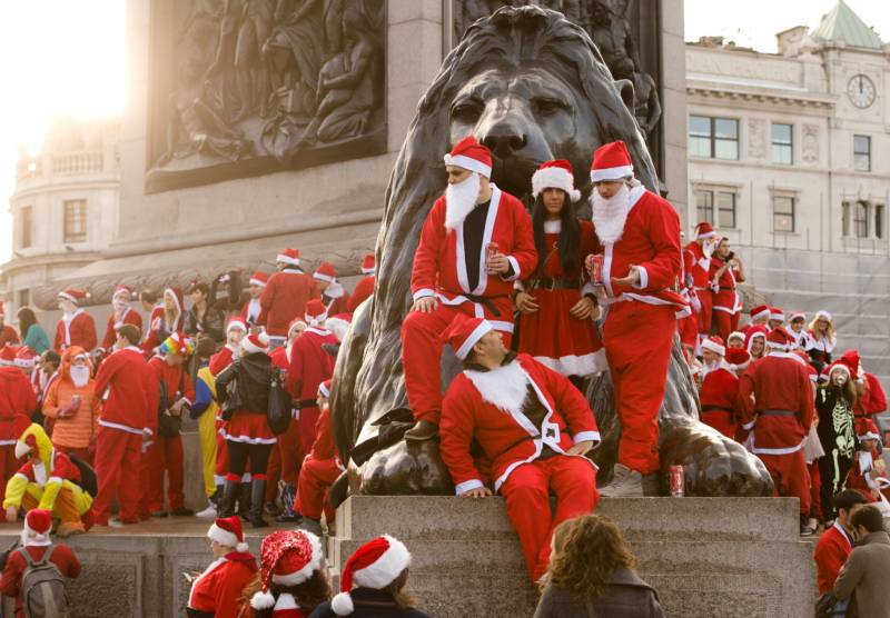 Revellers in Santa costumes gather around Nelson's Column during a 'Santacon' in Trafalgar Square in central London.