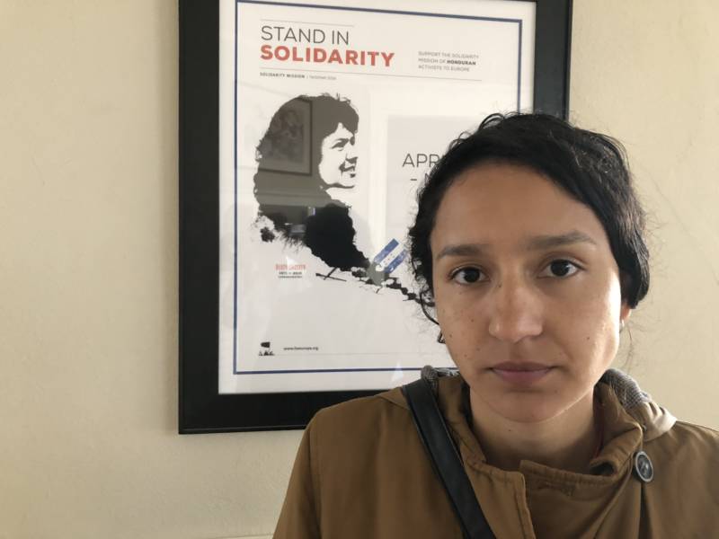 Bertha Zúñiga stands before an image of her mother at her cousin's home in Oakland on Oct. 31, 2018. Zúñiga was scheduled to speak on a panel at the UC Berkeley Law School’s International Human Rights Clinic.