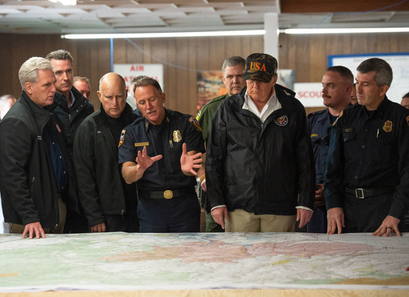Rep. Kevin McCarthy, Gov. Jerry Brown, Gov.-elect Gavin Newson and President Donald Trump listen to Cal Fire Chief Ken Pimlott during Trump's visit to the Camp Fire in Chico on Nov. 17, 2018.