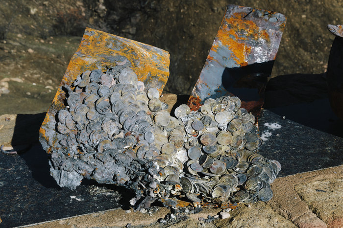 Coins melted together on Jones' property. He had a pot of coins for his grandchildren to pull from when they visited.