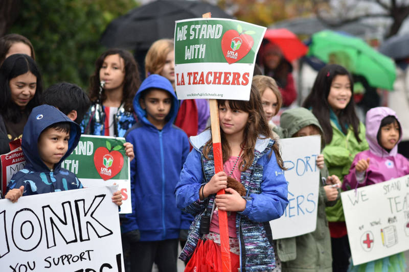 Students walk a picket line with their teachers and parents on the third day of the teachers' strike on January 16, 2019, in Los Angeles.