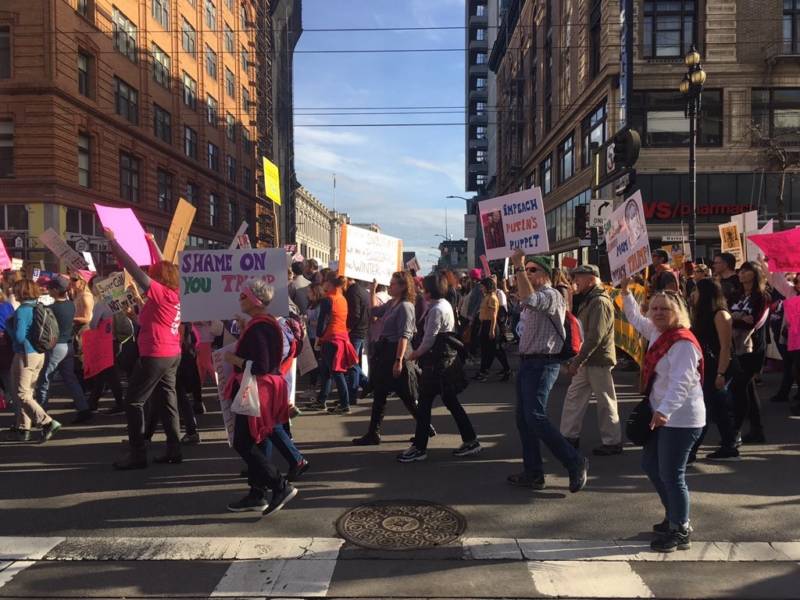 Thousands march down Market Street at the San Francisco Women's March. Some cheers: 'Dump Trump' and 'This is what democracy looks like.'