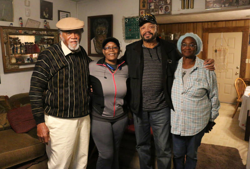 Four of 13 of the Marshall siblings stand in the living room of their family home in South Dos Palos. From left to right: Lee, Zella, Joe and Marilyn Marshall.