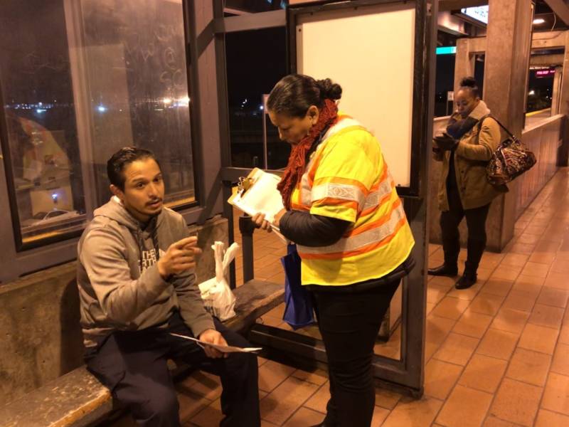 Felipe Enriquez speaks with a BART outreach staffer while waiting on platform at Coliseum station. Enriquez said BART's predawn will cost him time and money.
