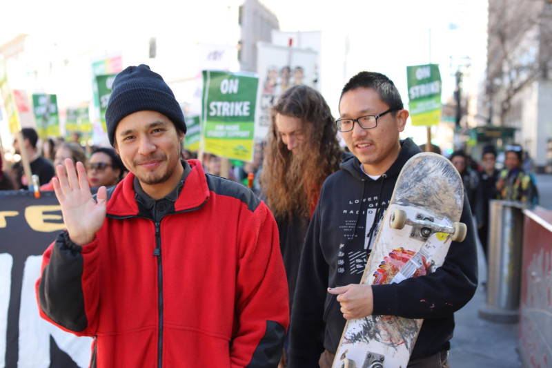 Gabriel Ramirez (left) and Jeffrey Cheung (right) of Unity, a queer skateboarding collective, march down Broadway.