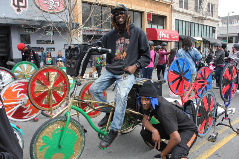 "RB" on bike he designed and Scraper Bike team leader Chuck Davis pose at the Black Joy Parade in downtown Oakland.